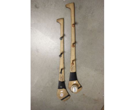 Two Ash Hurleys, one mounted with a sliotar, upcycled as coat racks 