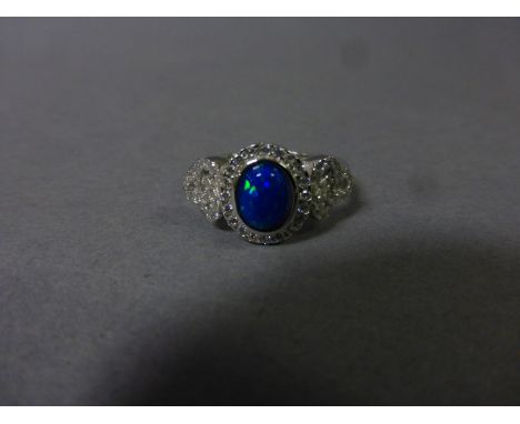 A silver, cz and blue opal ring