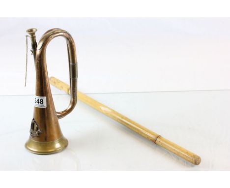 A copper and brass military bugle with special service group badge, together with a bamboo swagger stick