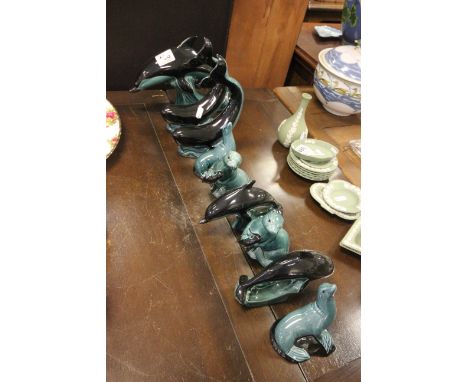 Quantity of Poole pottery dolphin and seal figures.