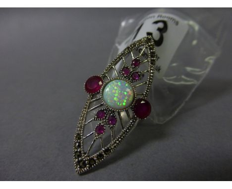 A silver Art Deco style ring set with garnets and a central opal