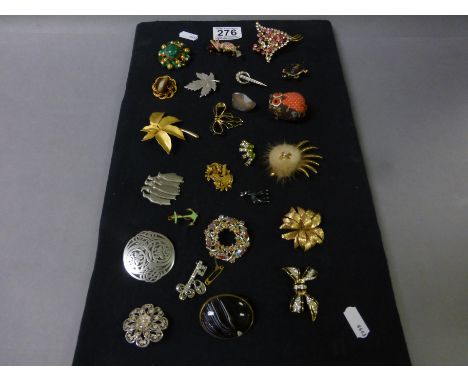 Display board with approximately 24 vintage brooches