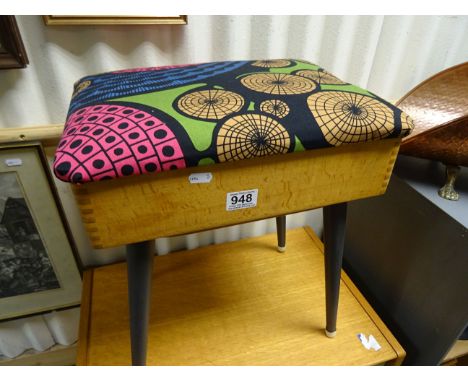A vintage oak sewing box with upholstered top