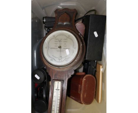 A vintage barometer, a book of stamps, plus a collection of binoculars