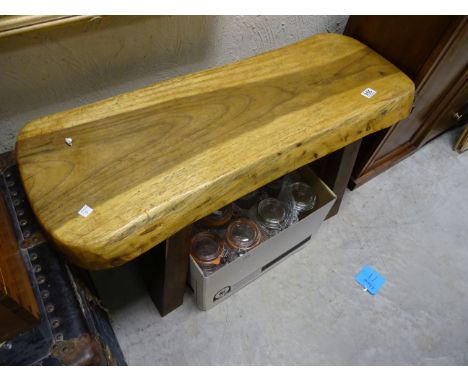 A heavy rustic wooden pig bench