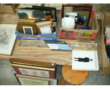 A collection of picture frames,signed prints, a wall mounted pot rack as new, Elton John sales catalogues boxed, a bar stool,