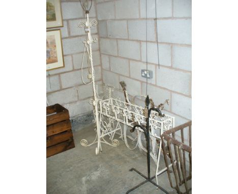 A Wrought iron lamp standard , spark guard, wall shelf, planter, 3 iron scroll bench supports and an iron stand. 