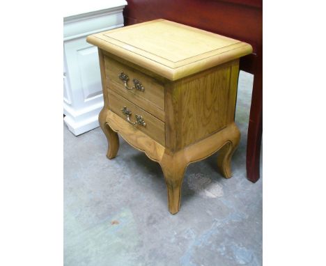 A French style light oak two drawer bedside table.