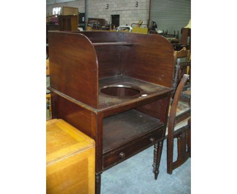 A 19th Century mahogany washstand , the top with a high gallery and a central circular aperture above a second shelf with a f