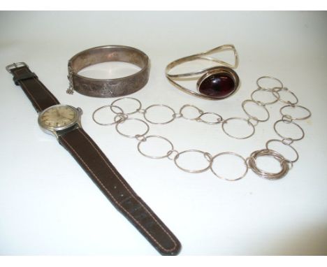 A silver bangle, with engraved decoration, together with, an amber and white metal bangle, a silver circular link necklace an
