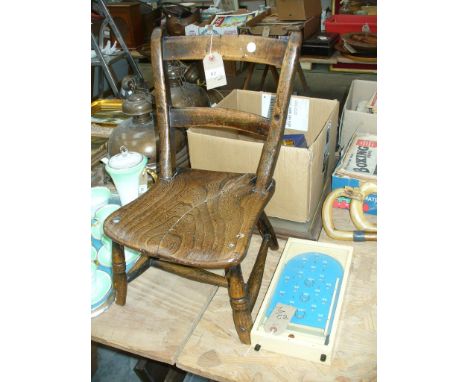 A 19th Century child's elm seated kitchen chair and a vintage Chad Valley bagatelle game.(2)