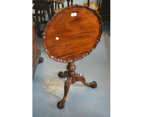 Reproduction mahogany wine table with a pie crust top, bird cage base and carved tripod 