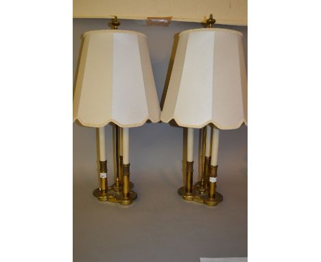 Pair of brass three light table lamps in the form of candles with matching shades, 30ins high 