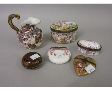 Oval porcelain box and cover decorated in relief, two other small Continental trinket boxes, similar heart shaped box and ano