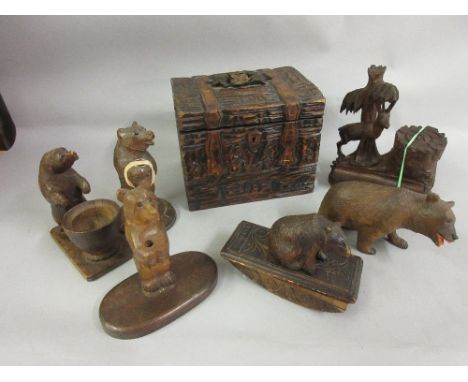 Group of six various carved Black Forest figures, together with a Black Forest tea caddy 