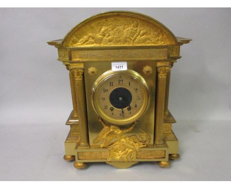 19th Century French gilt brass mantel clock of architectural form, the broken arch top inset with a classical frieze, the cir