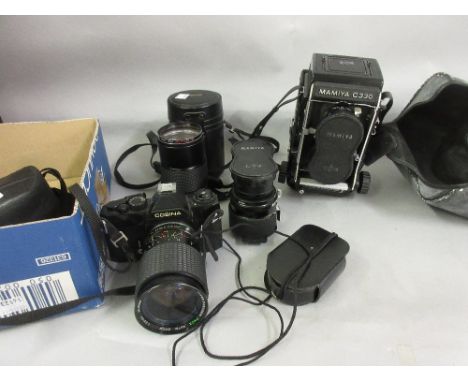 Mamiya cine camera with double lens and extra double lens, Konica 135mm lens, Cosina SLR camera and a light meter 