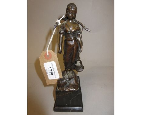 Brown patinated bronze figure of a girl water carrier, mounted on a square black marble plinth base 