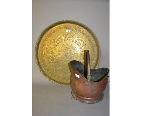 Circular Benares type brass tray with engraved decoration and a copper helmet shaped coal scuttle 