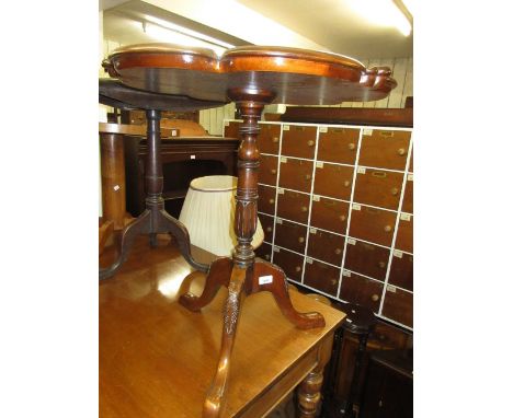 Reproduction mahogany pedestal table with shaped moulded top above a turned and carved column support and carved tripod base 