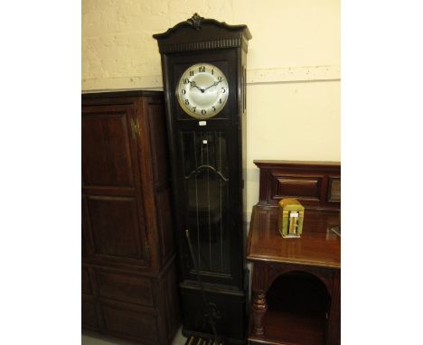 Early 20th Century oak longcase clock with a bar glazed and bevelled glass door, the circular silvered dial with Arabic numer