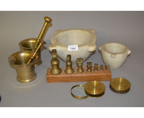 Two bronze pestles and mortars, two marble mortars, two brass lenses and a graduated set of brass weights 