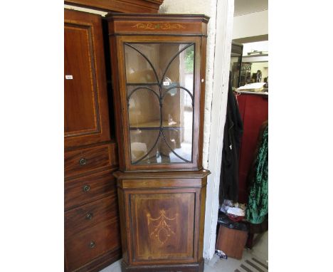 Edwardian mahogany crossbanded and inlaid floor standing corner cabinet, the glazed single door top above a panel door, raise