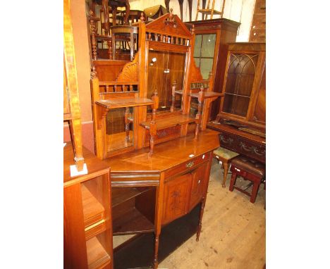 Late Victorian walnut chiffonier in Aesthetic style with a mirrored shelf back above a drawer, cupboards and open shelves 