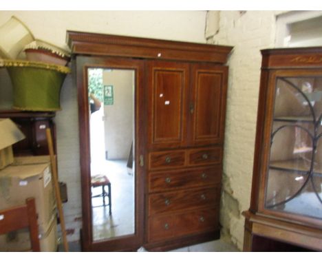 Edwardian mahogany crossbanded and inlaid wardrobe having moulded top above single full length mirrored door with opposing pa