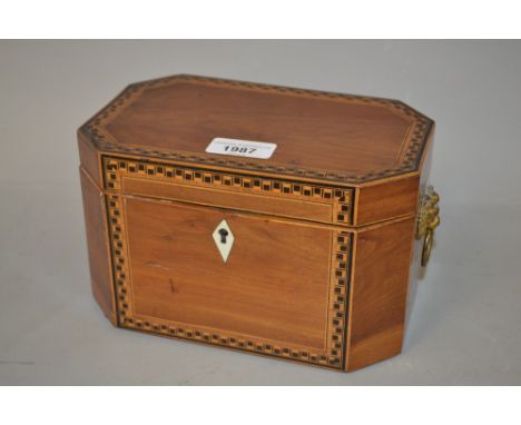 George III octagonal mahogany and inlaid tea caddy with lion mask ring handles 