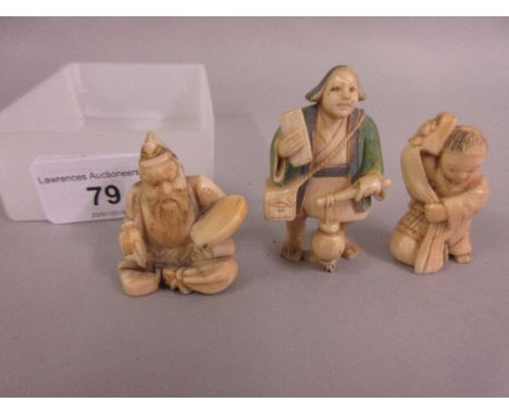 Japanese Meiji period netsuke in the form of a seated boy with a dragon costume, another of a seated figure holding a disc an