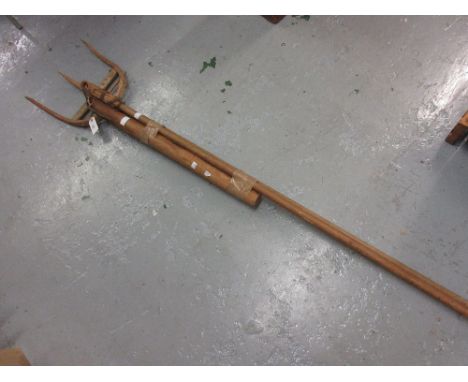 Late 19th / early 20th Century wooden hay fork and a pine handled thresher with leather strapping 