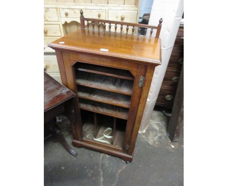 19th Century walnut music cabinet having spindle gallery top above a single door (lacking glass), with fitted interior on bra