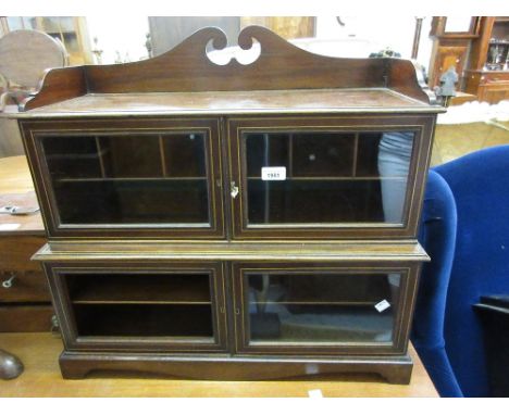 Edwardian mahogany line inlaid table top cabinet with a low gallery above two pairs of glazed doors raised on bracket feet 