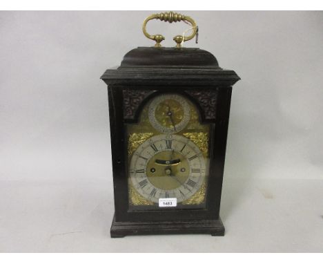 George III ebony and ebonised bracket or table clock, the dome case with brass carrying handle, the arched gilt brass dial wi