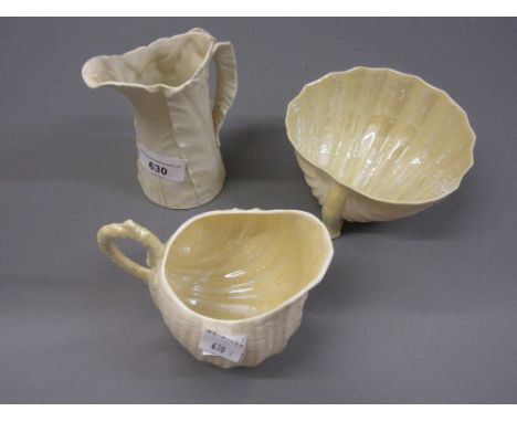 Belleek shell form sugar bowl and cream jug and a Royal Worcester leaf form jug 