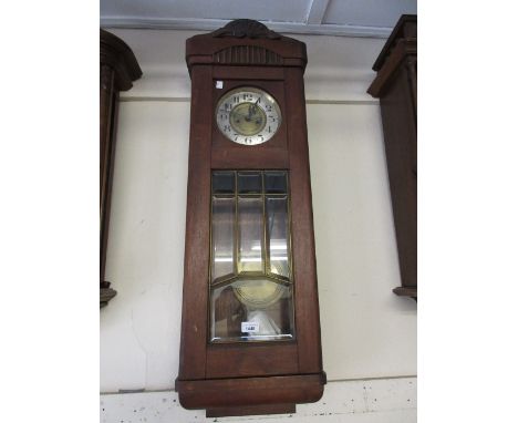Early 20th Century Continental mahogany cased wall clock of Vienna type, the rectangular case with a beveled glass door, the 