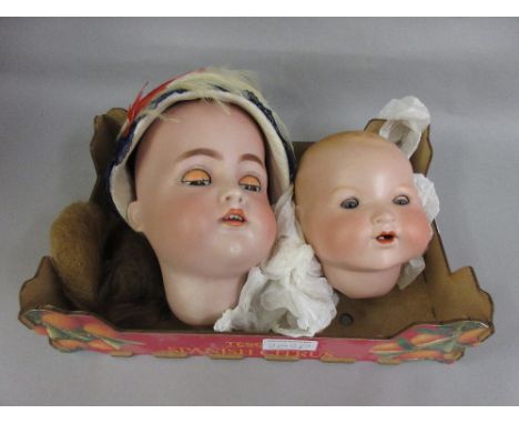 Simon and Halbig K. and R. bisque doll's head, size 70 with sleeping eyes, together with a similar A.M. bisque doll's head 