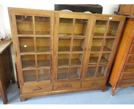 Mid 20th Century oak three door glazed bookcase with drawers below raised on bracket feetGood condition, no damage or restora