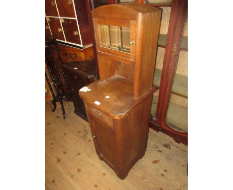 French Art Deco oak bedside cabinet having single door glazed top above a single drawer and further panel door on shaped supp