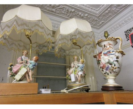 Pair of bisque porcelain figural table lamp bases with gilt metal mounts, silk shades having beaded tassels and a Victorian b
