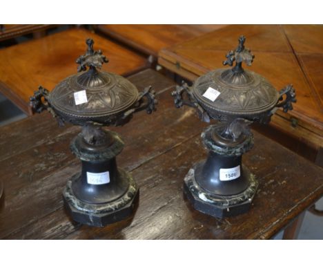 Pair of late 19th / early 20th Century French brown patinated bronze covered urns on circular black slate and marble plinth b