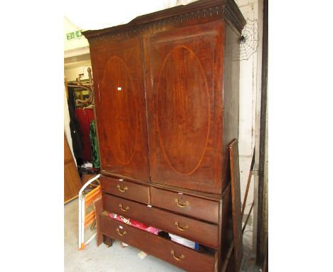 19th Century mahogany linen press having a moulded cornice above two flush panelled oval crossbanded doors fitted with two sl