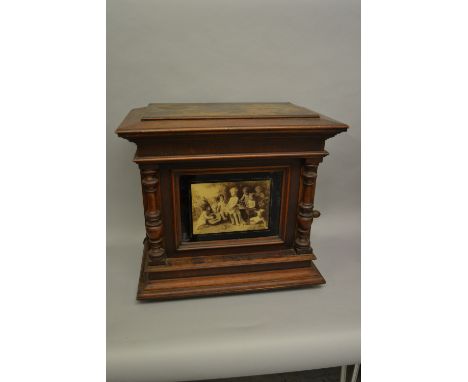 19th Century walnut cased upright polyphon, the glazed door decorated with a print of children enclosing a two comb crank win