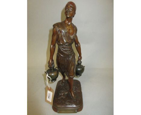 Marcel Debut, brown patinated bronze figure of a Tunisian water carrier, signed in the bronze, 12.5ins high 