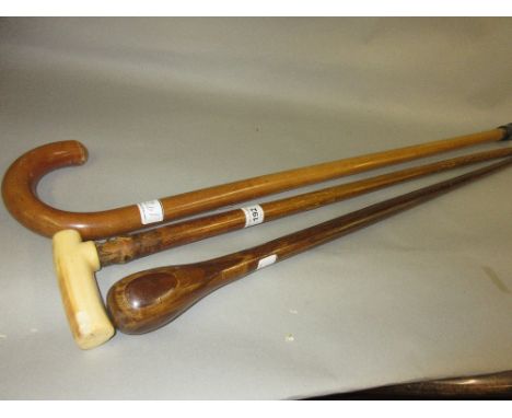 19th Century walking stick with carved ivory handle together with two other walking sticks 