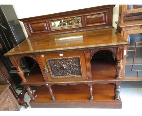 Late 19th or early 20th Century walnut side cabinet with a low mirrored moulded back above a carved central cupboard door fla