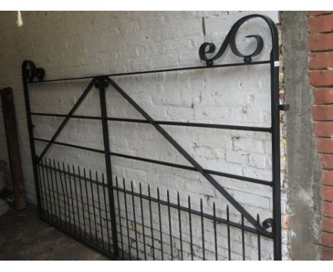 Modern good quality black painted wrought iron double gate having scroll work detailing and integral latch, 66ins high, 114in
