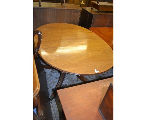 Mahogany twin pedestal dining table with a single central extra leaf (the table closing to form a single pedestal dining tabl