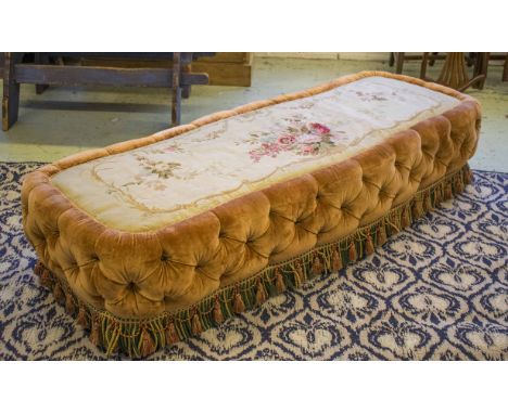 LONG STOOL, upholstered with a 19th century Aubusson tapestry top, buttoned velvet sides and tasselled valance, 188cm W x 72c